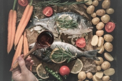Grilled dorado fish with aromatic herbs and vegetables